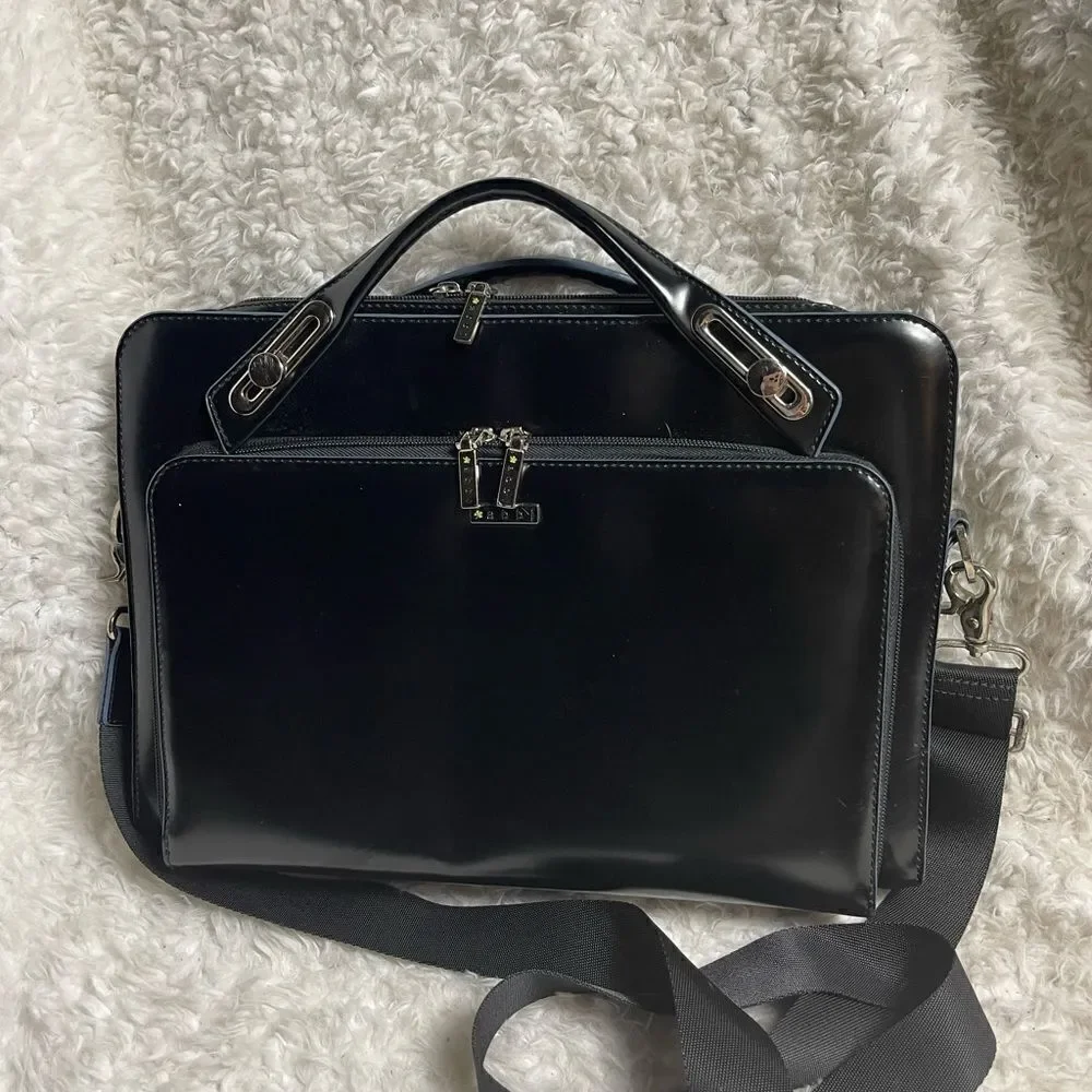 Abbi New York Laptop/Briefcase Carrier Black leather inside padded fabric.